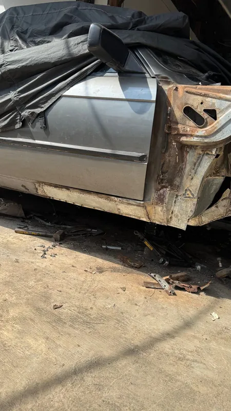 BMW E30 side with the front wing off, rusted A-pillar and sill