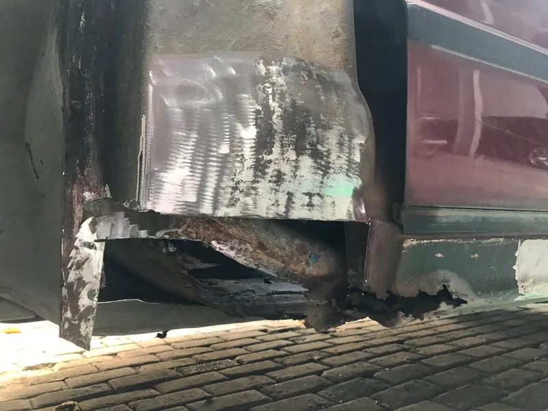 Rust and an old repair patch at the rear sill of the E34