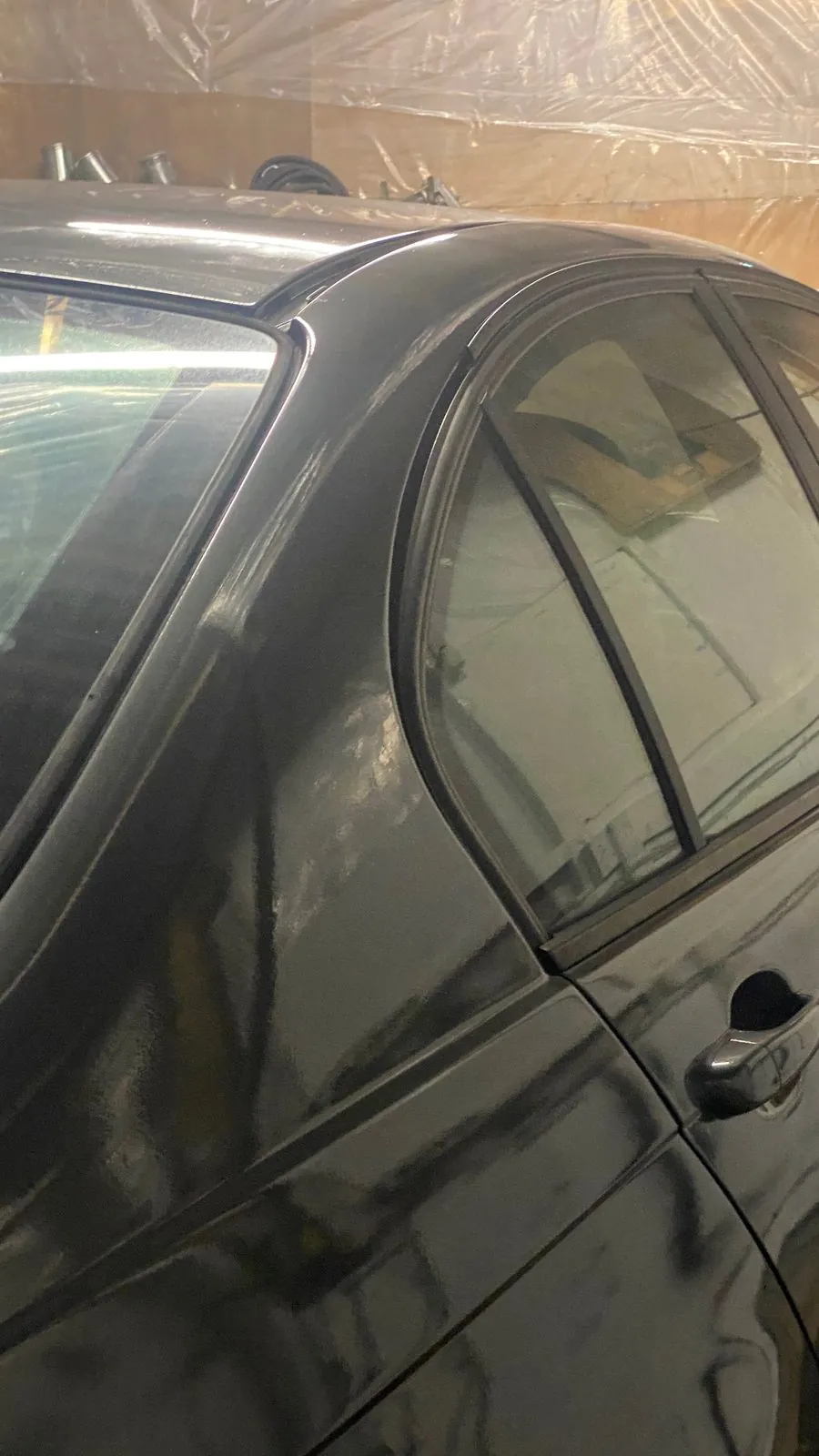 E46 sprayed dark grey, side, inside the plastic-sheeted booth
