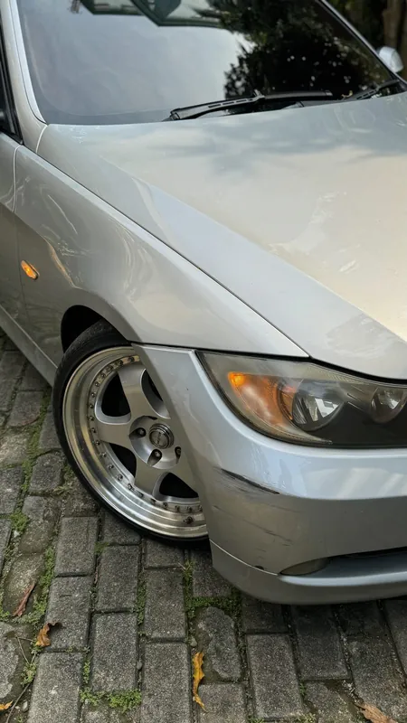 Silver E90 front wing, bonnet and headlight with a scuffed bumper corner