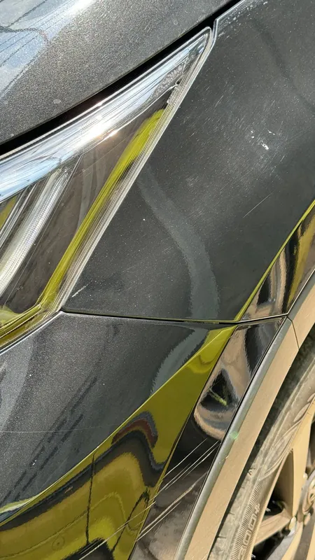 Crease damage on the rear wing beside the tail light