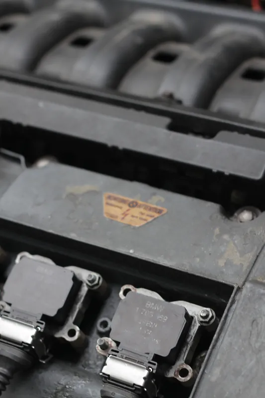 Row of ignition coils on a BMW six-cylinder valve cover