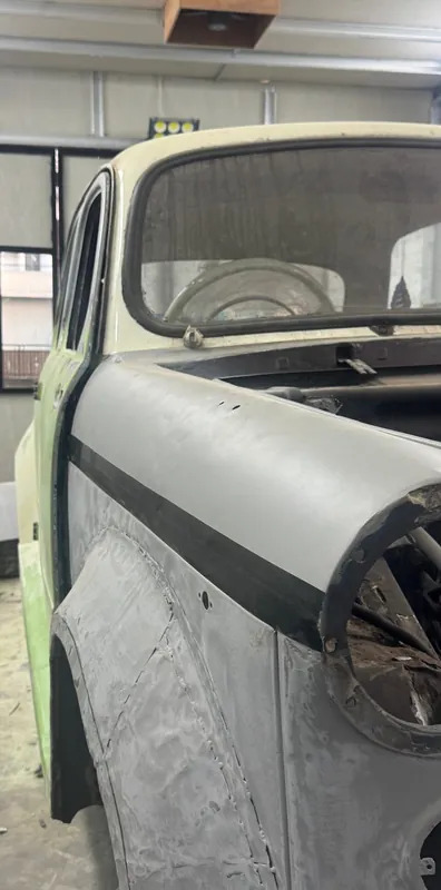 Fiat front wing with a black seam bead and primer