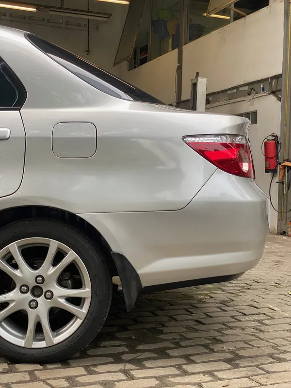 Rear quarter, fuel flap and wheel of the silver Honda City