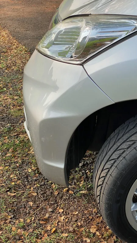 Front wing crease and headlight corner of the silver MPV