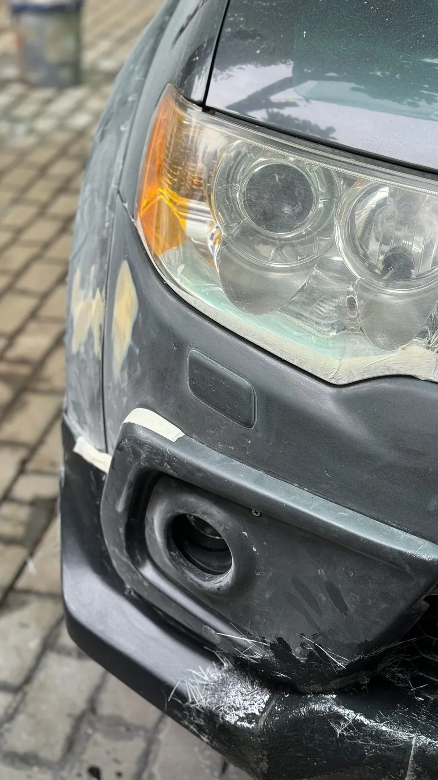 Headlight, fog lamp surround and bumper corner of Pajero Sport with masking tape and fibreglass