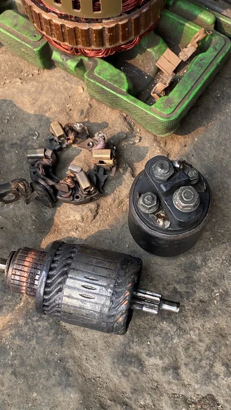 Starter motor armature, brushes and housing laid out on the floor