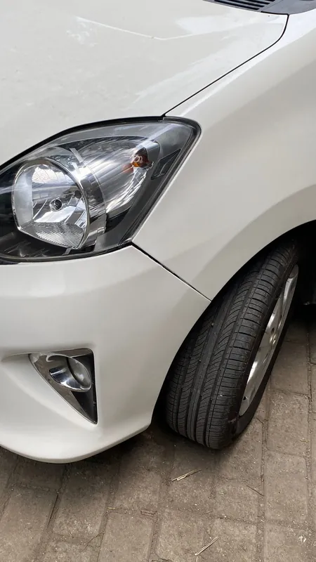Front wing, headlight and fog lamp of the white Agya